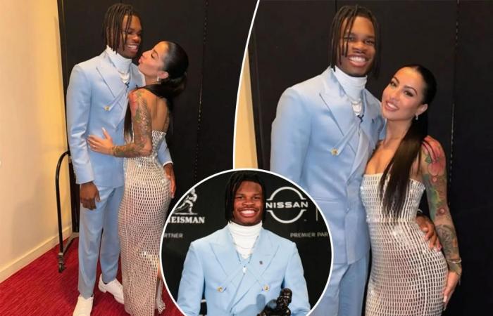 Travis Hunter y su prometida Leanna Lenee se ponen cómodos durante la victoria del Trofeo Heisman